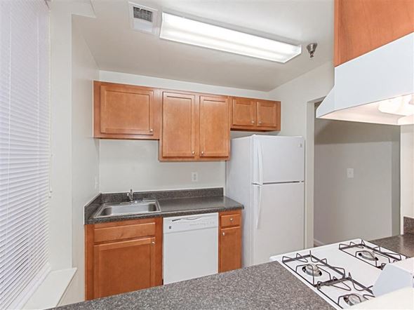 Washington apartment for rent - kitchen with refrigerator, dishwasher, gas range and wood cabinetry at the whitelaw apartments in washington dc
