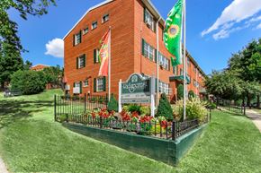 Washington apartment for rent - A red brick building with a green lawn in front.