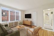 Washington apartment for rent - A living room with a couch, chair, and television.