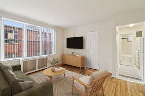 Washington apartment for rent - A living room with a couch, chair, and television.