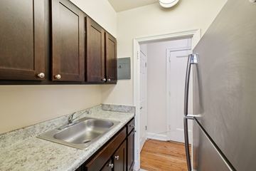 Washington apartment for rent - A kitchen with a sink and a refrigerator.