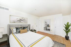 Washington apartment for rent - bedroom with bed, nightstand, and closet at jasper place apartments in washington dc