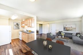 Washington apartment for rent - a living room with a black dining table and a kitchen at 734 longfellow tax credit apartments in washington dc