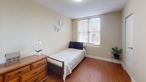 Washington apartment for rent - A bedroom with a bed, dresser, and a window.
