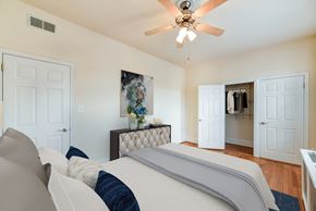 Washington apartment for rent - bedroom with bed, dresser, large closet, ceiling fan and hardwood floors at the norwood apartments in adams morgan washington dc