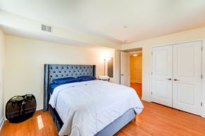 Washington apartment for rent - bedroom with bed, nightstand, large closet and view of bathroom at park vista apartments in washington dc