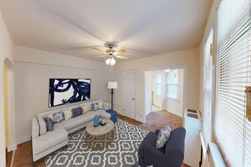 Washington apartment for rent - a living room with a white couch and a ceiling fan