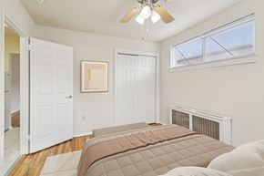 Washington apartment for rent - A bedroom with a large bed and a ceiling fan.