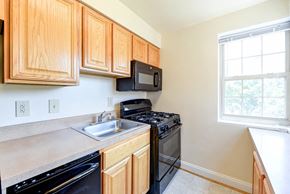 Washington apartment for rent - kitchen with gas range and window at shipley park apartments in shipley terrace washington dc