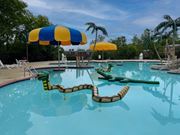 Washington apartment for rent - A pool with a blue and yellow umbrella and a green inflatable.