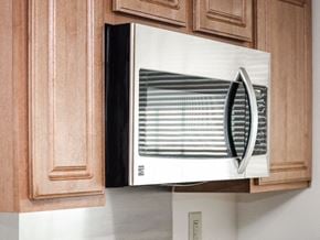 Washington apartment for rent - close up of microwave and cabinets in kitchen at t street apartments in washington dc