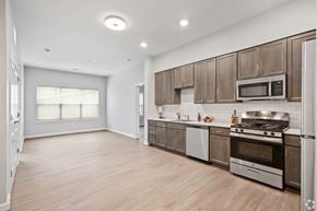 Washington apartment for rent - A kitchen with wooden cabinets and stainless steel appliances.