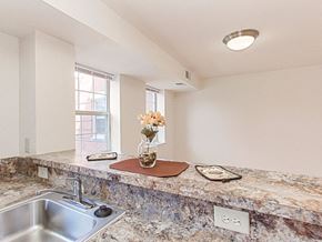 Washington apartment for rent - kitchen with breakfast bar and view of dining area at the oaks apartments in washington dc