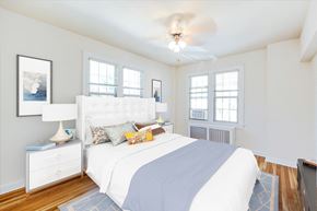 Washington apartment for rent - bedroom with bed, nightstands, large windows, hardwood flooring and ceiling fan at the frontenac apartments in washington dc