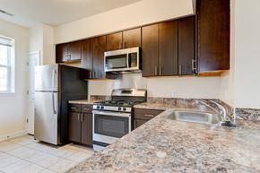 Washington apartment for rent - kitchen with espresso cabinetry, breakfast bar and stainless steel appliances at sheridan station south townhomes in washington dc