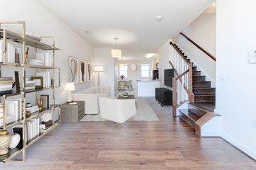 Washington apartment for rent - a living room with a staircase and a white couch