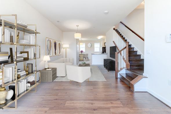 Washington apartment for rent - view of large living area with sofa, sitting area, bookshelves and staircase at sheridan station south townhomes in washington dc