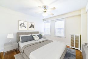 Washington apartment for rent - bedroom with bed, nightstands, hardwood floors, ceiling fan and large windows at wakefield hall apartments in washington dc