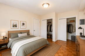 Washington apartment for rent - A bedroom with a large bed and a wooden dresser.