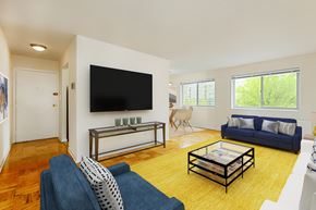Washington apartment for rent - living area with wood flooring, sofa, love seat, coffee table, tv and large windows at chillum place apartments in washington dc