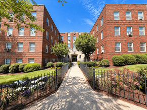 Washington apartment for rent - A long, narrow alleyway between two red brick apartment buildings.