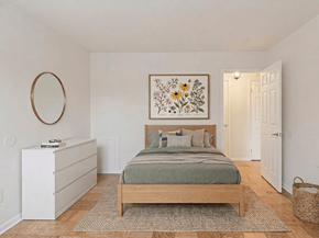 Washington apartment for rent - A bedroom with a bed, dresser, and a framed picture on the wall.