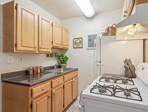Washington apartment for rent - A kitchen with wooden cabinets and a white stove.