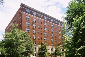 Washington apartment for rent - a tall brick building with trees in front of it