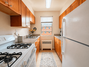 Bethesda apartment for rent - A kitchen with a white gas stove and a white refrigerator.