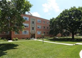 Bethesda apartment for rent - A red brick apartment building with a tree in front.