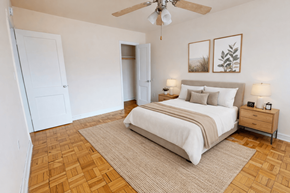 Washington apartment for rent - A bedroom with a bed, nightstand, and two framed pictures on the wall.