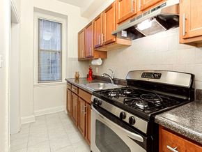Washington apartment for rent - a kitchen with a stove top oven next to a window at the calverton apartments in washington dc