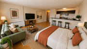 Washington apartment for rent - A bedroom with a large bed and a couch.