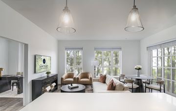 Winchester apartment for rent - A living room with a white couch and a painting of a tree on the wall.