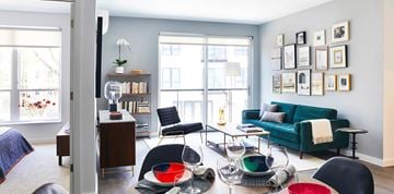 Jamaica Plain apartment for rent - A living room with a green couch and a coffee table with bowls on it.