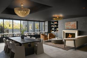 Winchester apartment for rent - A modern dining room with a fireplace and a large table.