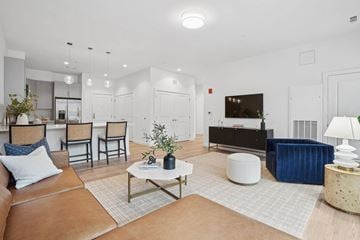 Winchester apartment for rent - A living room with a brown leather couch and a coffee table.