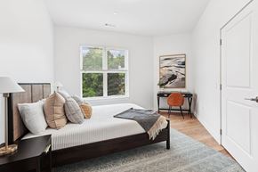 Winchester apartment for rent - A bedroom with a large bed and a desk with a chair.