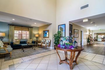 Fountain Valley apartment for rent - A living room with a couch, chairs, and a table with a vase of flowers on it.