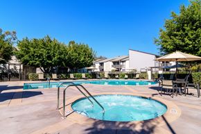 Costa Mesa apartment for rent - A swimming pool surrounded by trees and chairs.