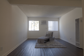 Fullerton apartment for rent - A large bedroom with a bed and a chair.
