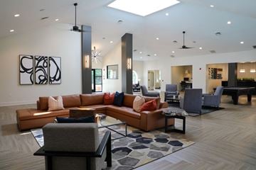 Owings Mills apartment for rent - a large living room with couches and chairs and a table