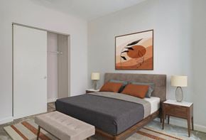 Baltimore apartment for rent - A bedroom with a bed, nightstands, and a painting on the wall.at 405 W Redwood Apartments, Maryland, 21201