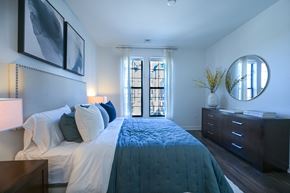 Pikesville apartment for rent - a bedroom with a large bed and a mirror on the wall at Ingram Manor, Pikesville, MD