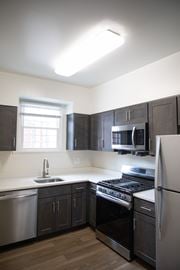 Pikesville apartment for rent - A kitchen with a stove, sink, and refrigerator.