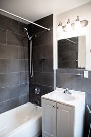 Pikesville apartment for rent - A white bathroom sink with a white tub and a white cabinet.