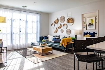 Owings Mills apartment for rent - A modern living room with a green couch and a coffee table.