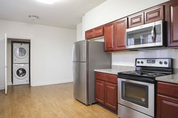 A kitchen with wood cabinets and stainless steel appliances