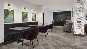 Pikesville apartment for rent - a room with tables and chairs and a bar in the background at The Encore at Ingram Manor, Pikesville