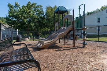 A playground with a slide at a park